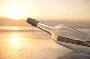 freelance writing message in a bottle under a sunset