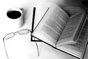 an suthors book, glasses and a mug of coffee