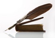 Writer's quill with feather & a completed novel